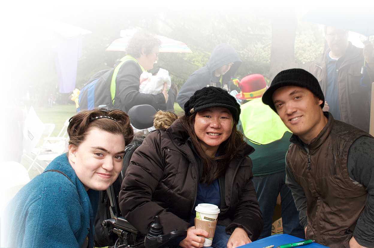 Photo of three young supporters at a Disability Capitol Action Day in Sacramento.